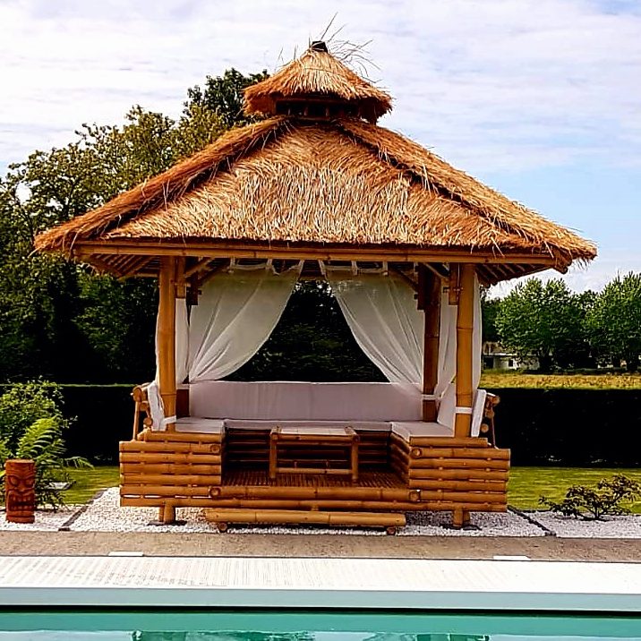 Paillote en Bambou dans jardin exotique en bord de piscine toiture Alang Alang